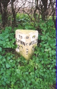 AB03	A milepost in Burnham Overy - 27 miles to Lynn, 5 miles to Wells.