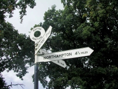 P9290013	The sign at Gayton Junction - Northsmpton 4.75 miles, Brentford 77 miles and Brauston 16.5 miles.