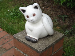 P2011DSC02947	A ceramic cat on a gatepost.