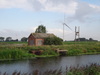 A wind turbine and pumping station.