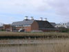 Snape Maltings viewed from across the River Alde.