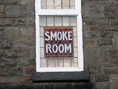 P20077088422	A 'Smoking room' sign on a window of a pub in Treforest.