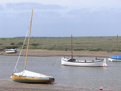 P20115236020	Boats in a channel above Burnham Overy Staithe.