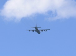 P20115246330	A Hercules flies overhead.