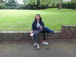 P2012DSC01069	Sencan changing her shoes in Sayes Court Park.