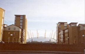 W10	The Millennium Dome viewed between two new blocks of flats.